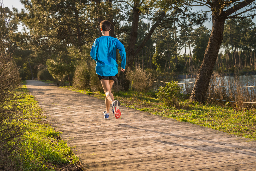 Athletic young man running in the nature. Healthy lifestyle