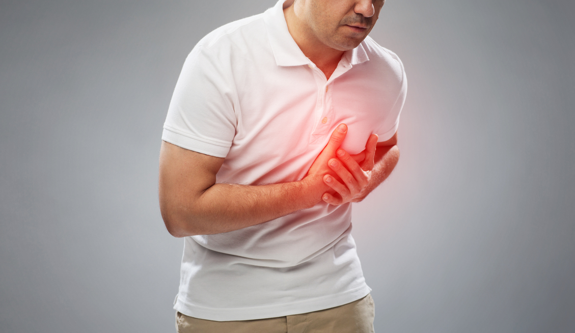 people, healthcare and problem concept - close up of man suffering from heart ache over gray background