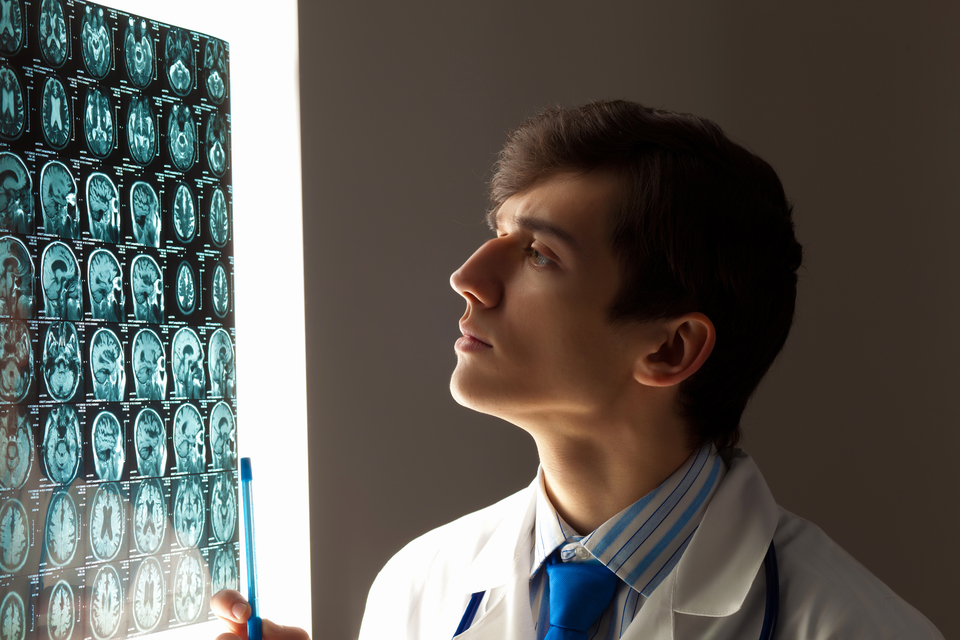 Image of male doctor looking at x-ray results