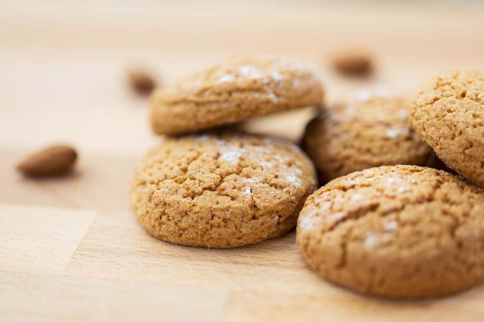 food, baking and eating concept - close up of homemade oatmeal cookies on wooden table