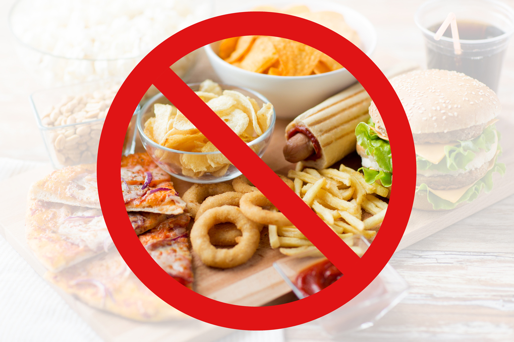 fast food, low carb diet, fattening and unhealthy eating concept - close up of fast food snacks and cola drink on wooden table behind no symbol or circle-backslash prohibition sign