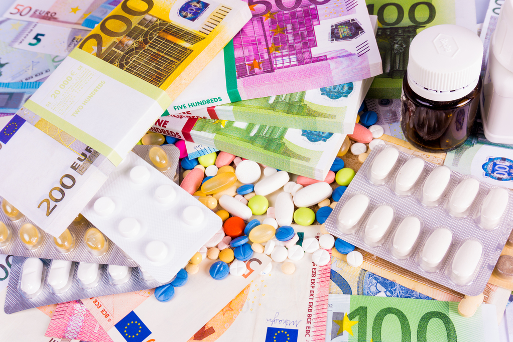 Health insurance concept with  pills and money.  Medicine cost