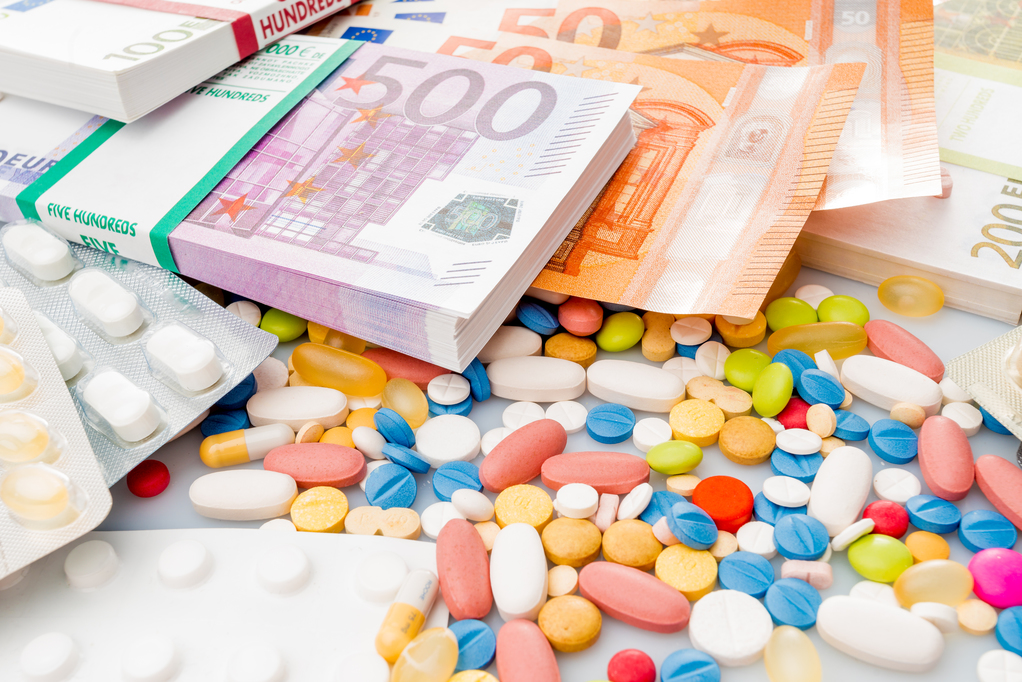 Money and pills. Pills of different colors on money. medicine concept. Euro cash