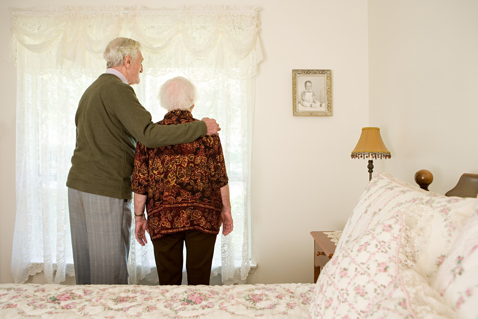 Elderly couple in their bedroom