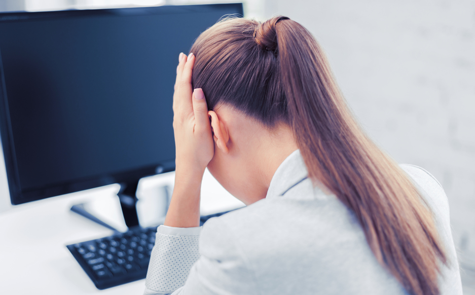 business, office, school and education concept - stressed businesswoman with computer at work