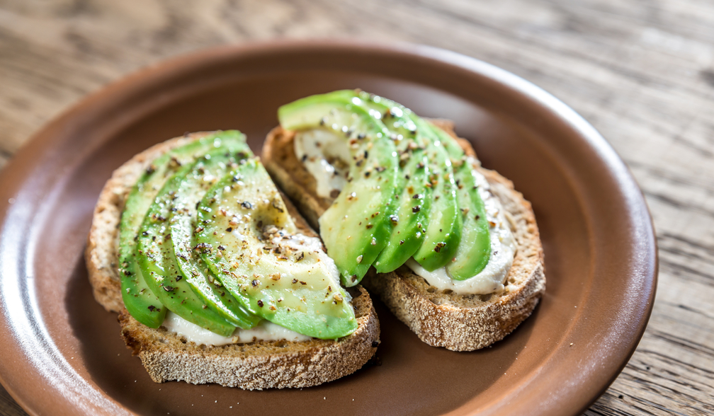 Toasts with tahini sauce and sliced avocado